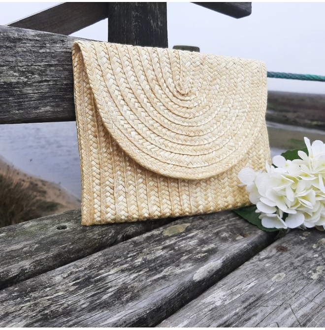 Includes woven lining Straw clutch
