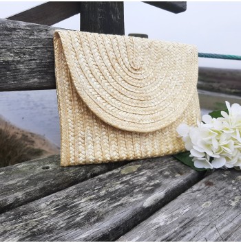 Includes woven lining Straw clutch